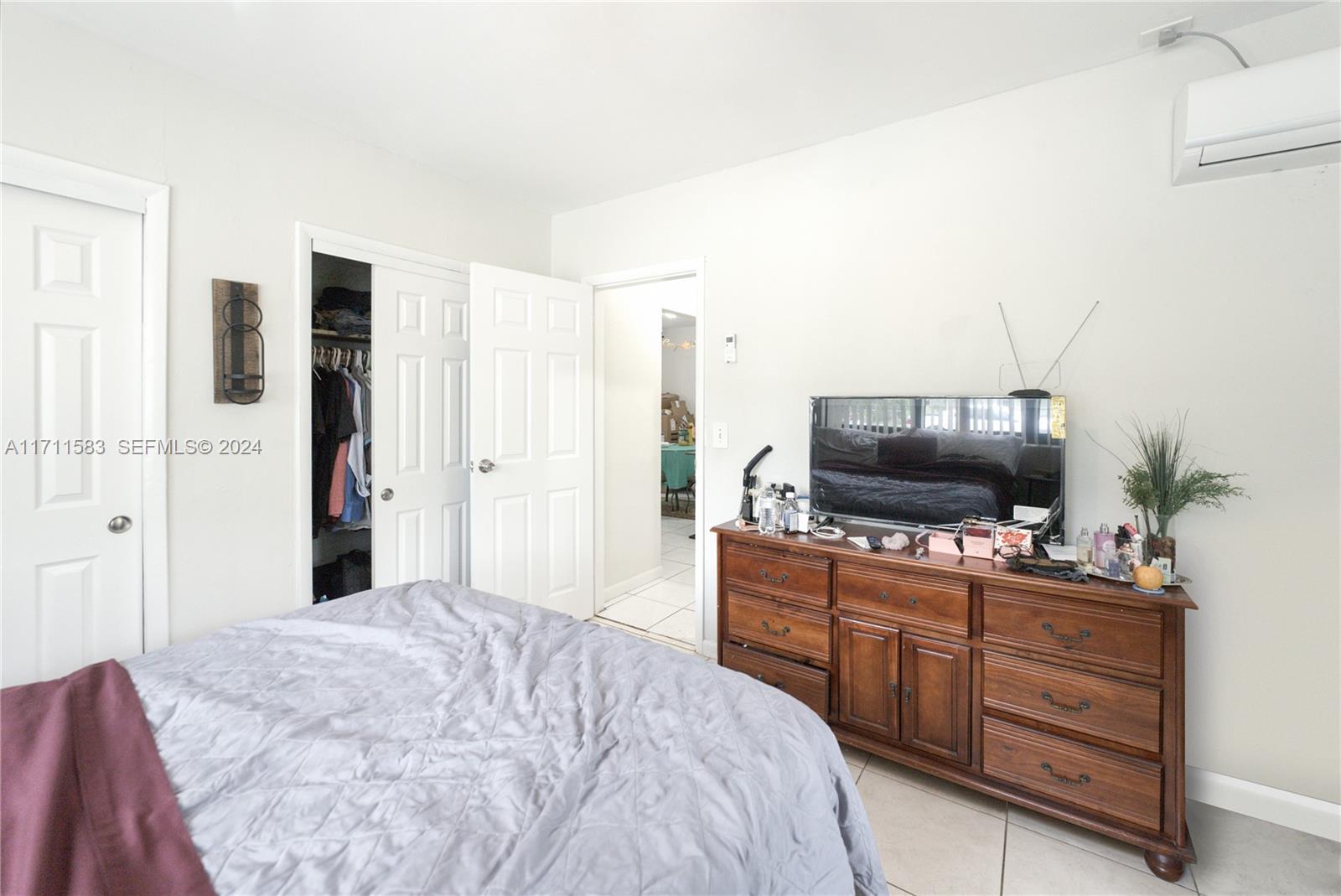 175 Northwest 68th Street Miami, FL 33150 - Photo 13 of 31 a bedroom with a bed and a flat screen tv