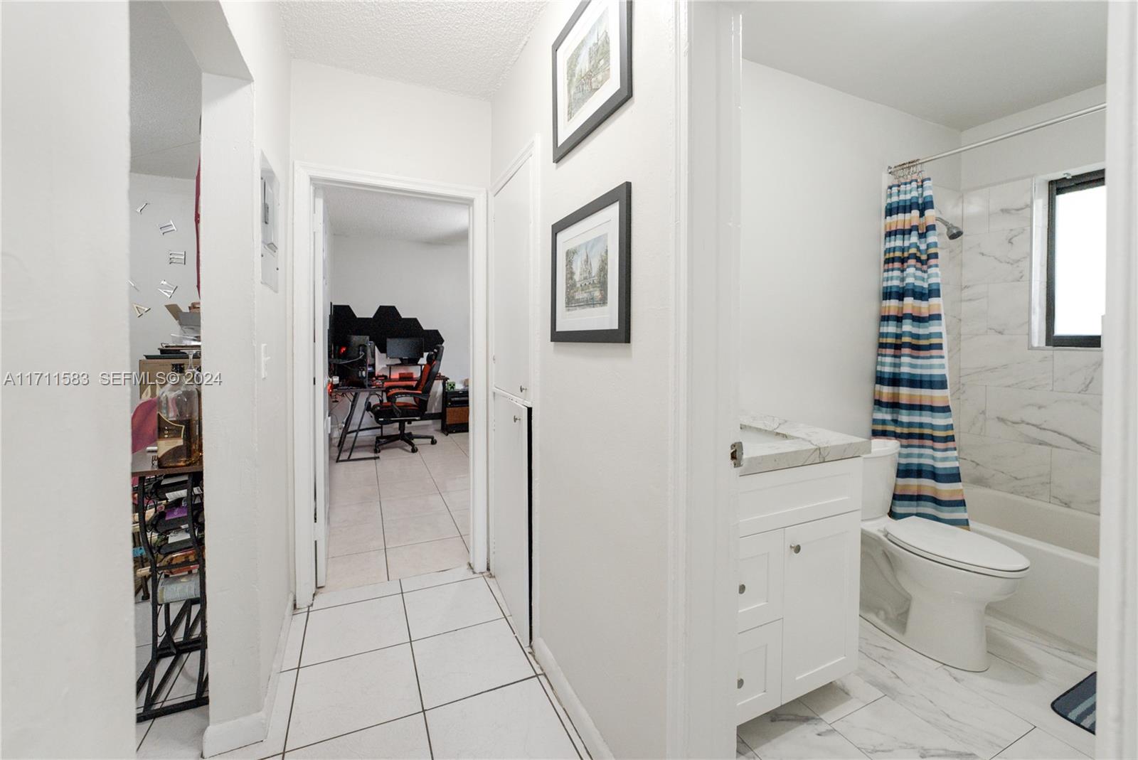 175 Northwest 68th Street Miami, FL 33150 - Photo 14 of 31 a bathroom with a toilet a sink and a window