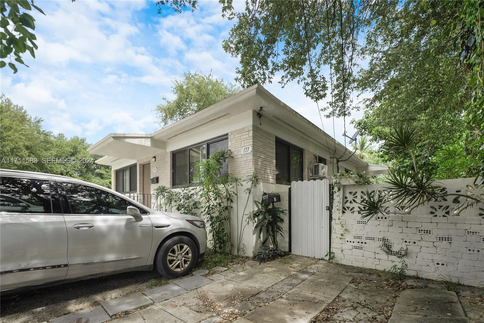 175 Northwest 68th Street Miami, FL 33150 - Photo 17 of 31 a car parked in front of white house