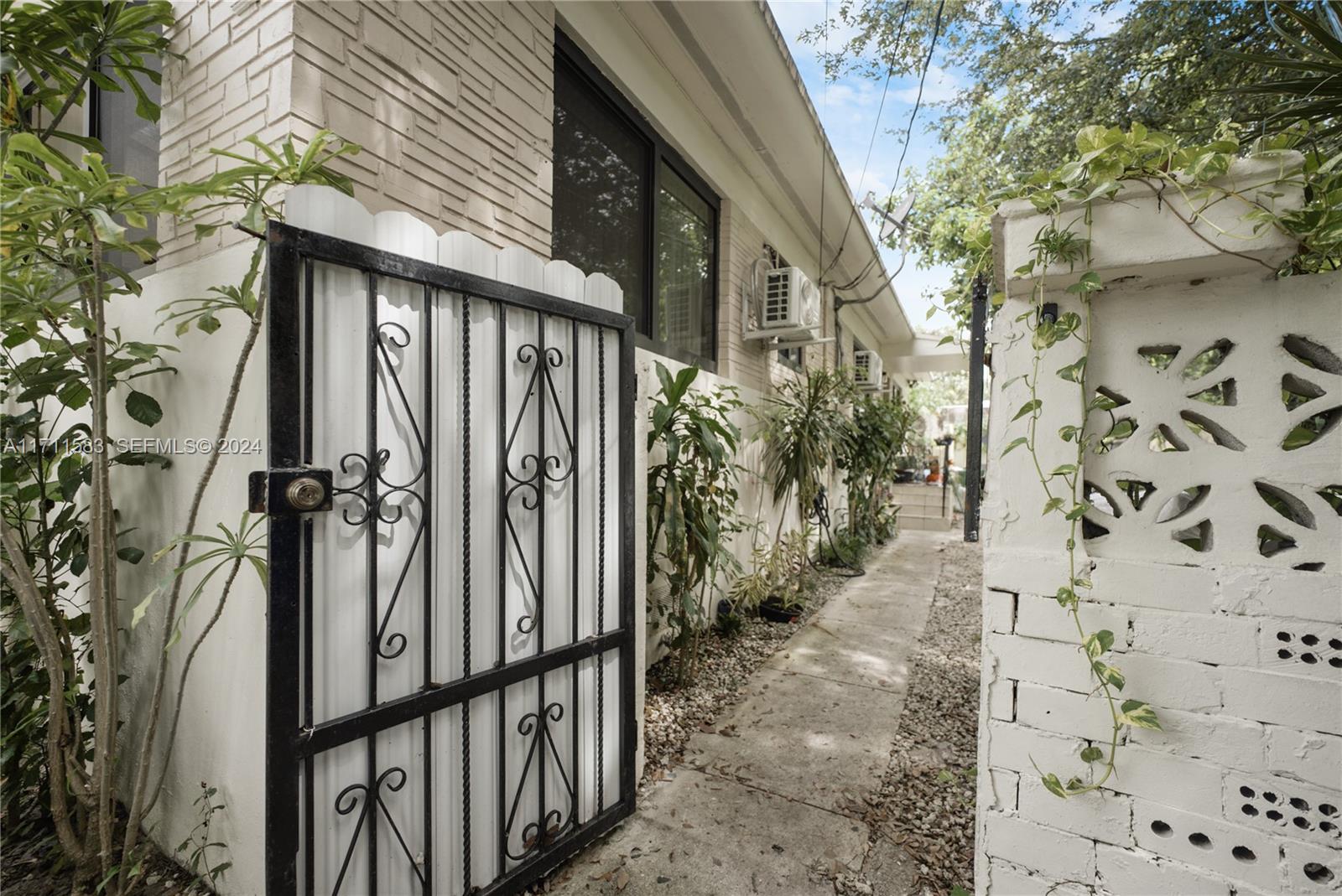175 Northwest 68th Street Miami, FL 33150 - Photo 18 of 31 a view of a pathway of a house with wooden fence
