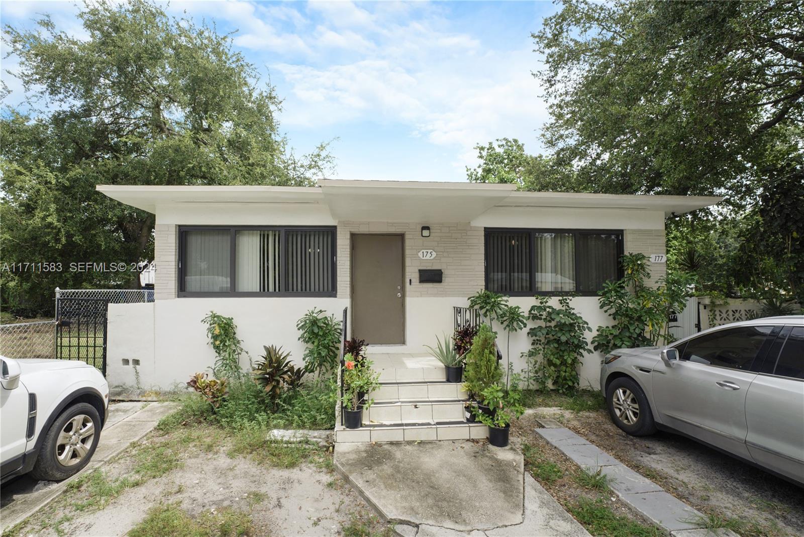 175 Northwest 68th Street Miami, FL 33150 - Photo 2 of 31 front view of a house with a yard