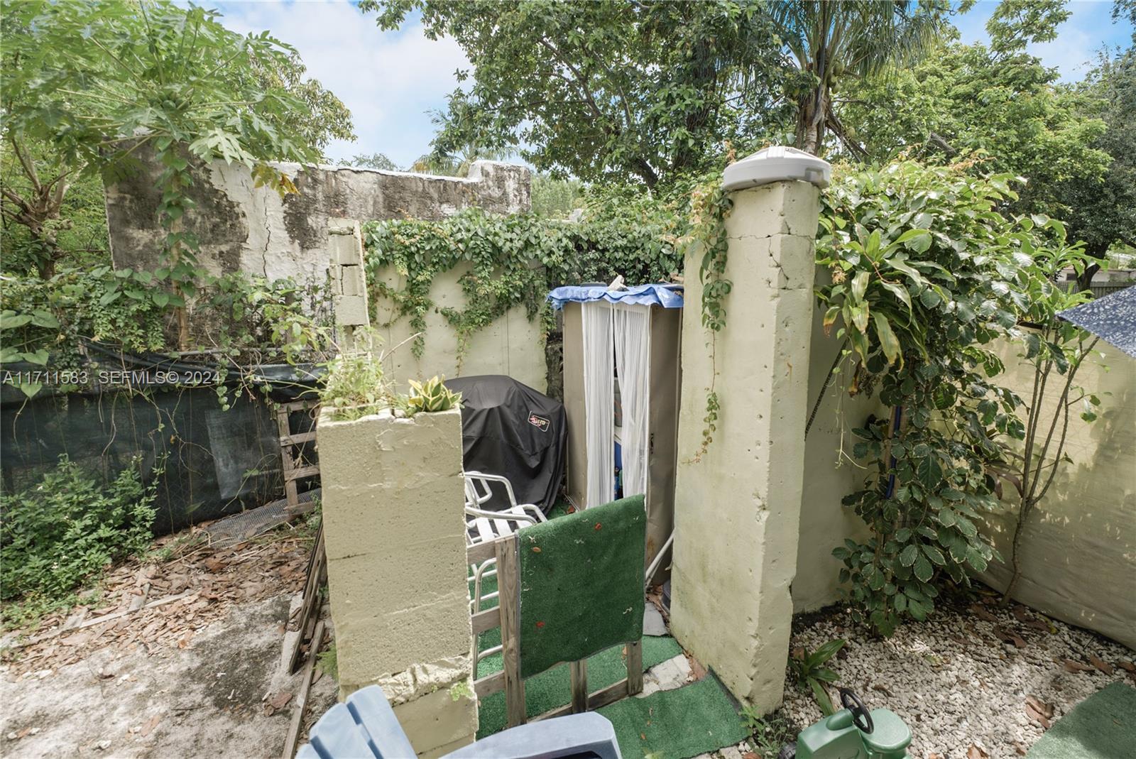 175 Northwest 68th Street Miami, FL 33150 - Photo 24 of 31 a view of a patio with table and chairs and potted plants