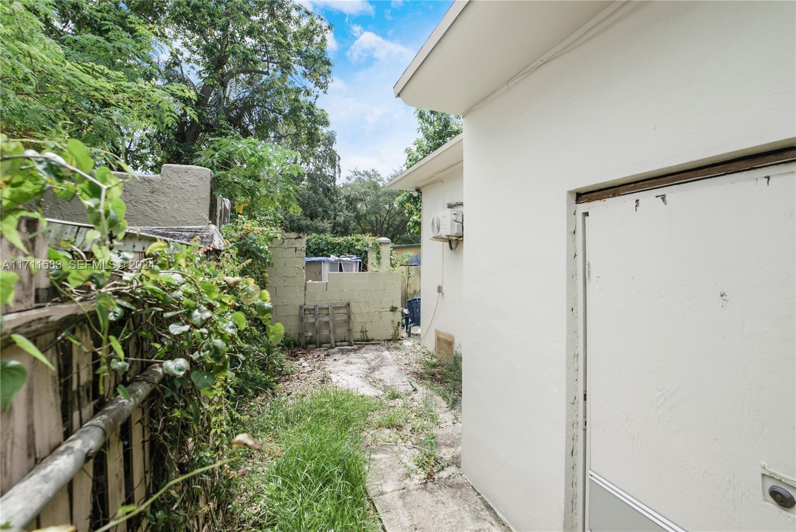 175 Northwest 68th Street Miami, FL 33150 - Photo 26 of 31 a backyard of a house with a table and chairs