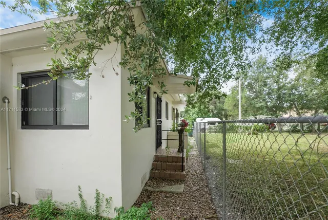 a pathway of a house with a yard