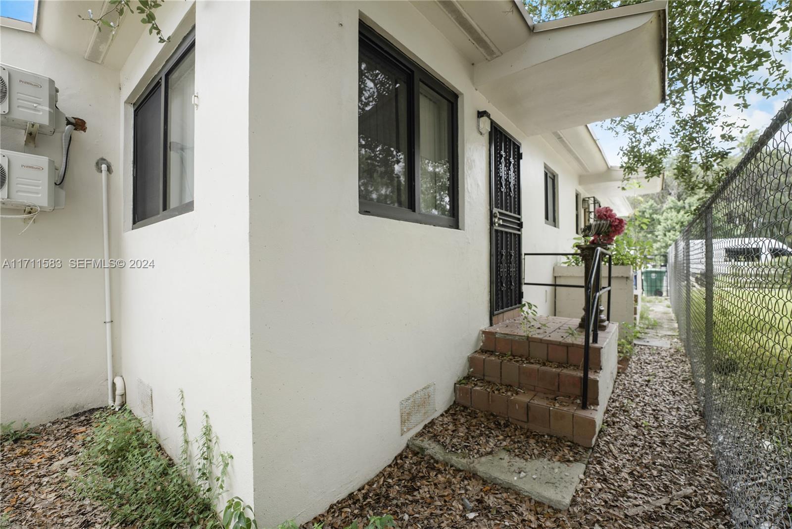 175 Northwest 68th Street Miami, FL 33150 - Photo 29 of 31 a pathway of a house with a yard
