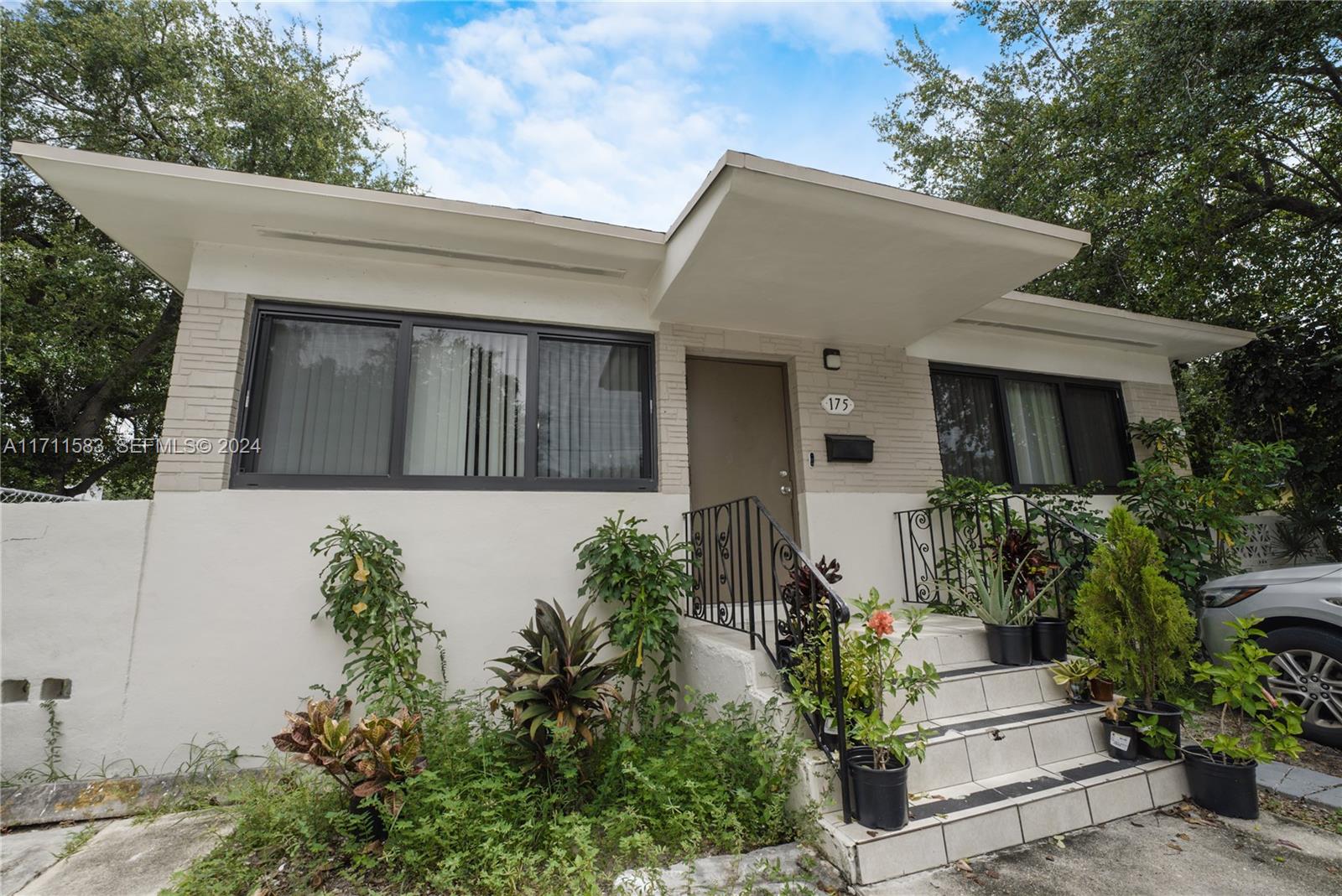 175 Northwest 68th Street Miami, FL 33150 - Photo 3 of 31 a front view of a house with potted plants