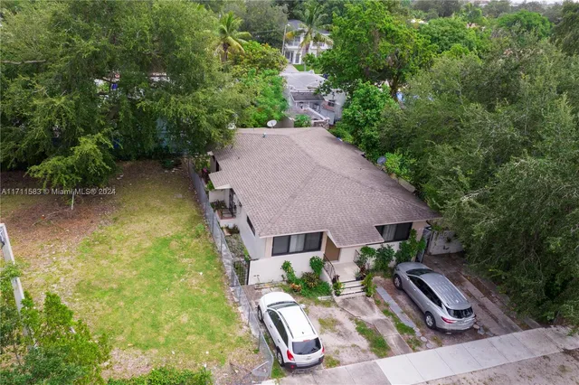 an aerial view of a house with garden space and street view