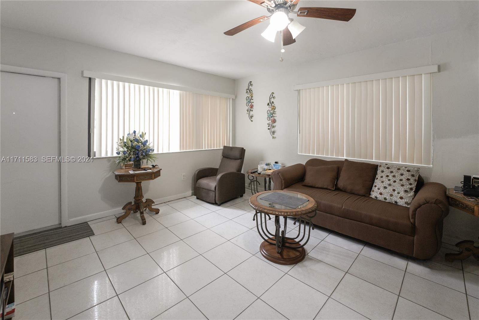 175 Northwest 68th Street Miami, FL 33150 - Photo 5 of 31 a living room with furniture and a chandelier