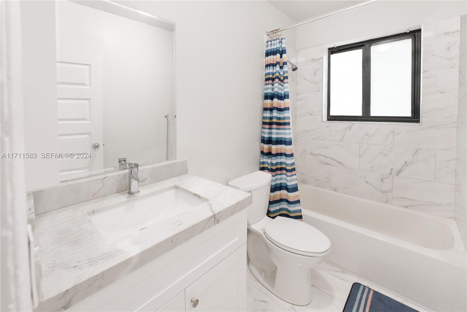 175 Northwest 68th Street Miami, FL 33150 - Photo 9 of 31 a bathroom with a sink a toilet and a bathtub