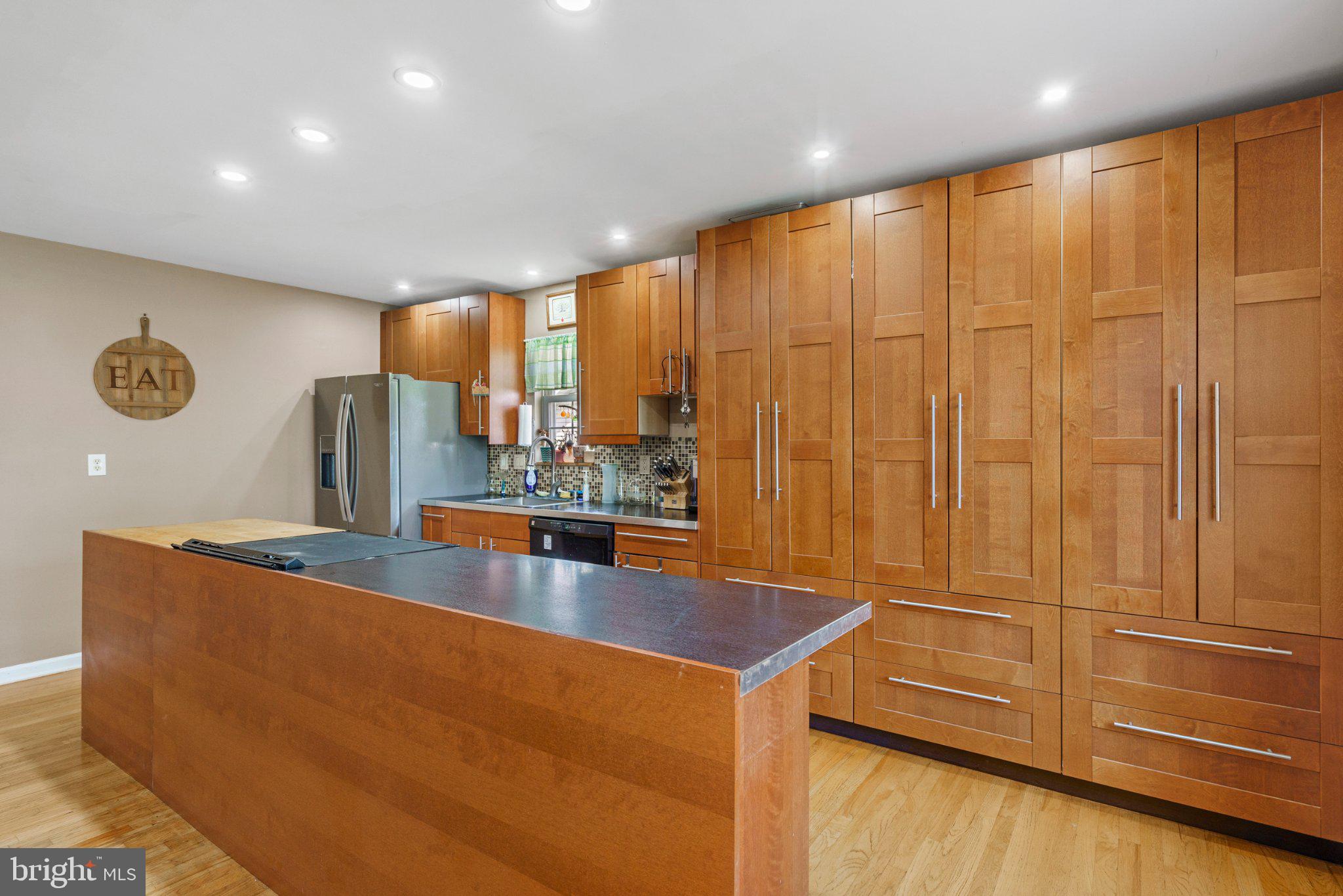 120 Peter Rabbit Drive Ranson, WV 25438 - Photo 17 of 31 Sleek modern kitchen with warm wood tones.