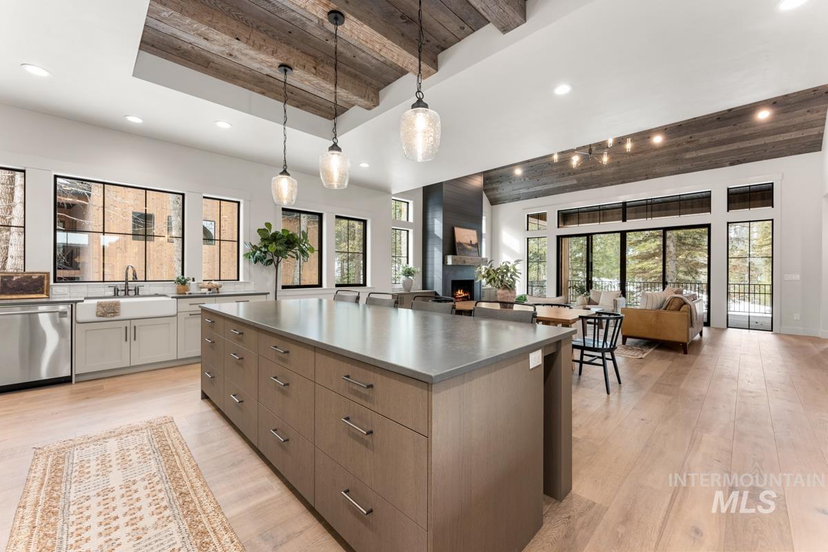 68 Ponderosa Ridge Donnelly, ID 83615 - Photo 28 of 29 Kitchen with a wood ceiling with exposed beams, light wood-style flooring, open floor plan, stainless steel dishwasher, and a spacious island