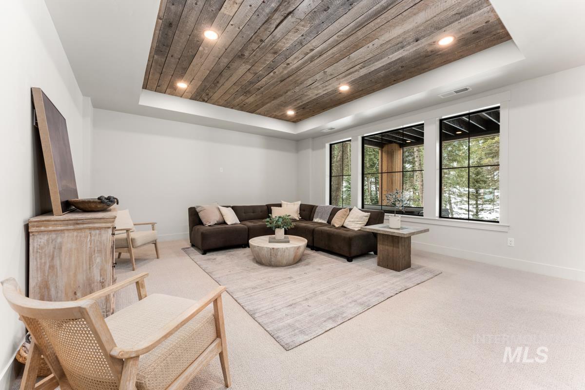 68 Ponderosa Ridge Donnelly, ID 83615 - Photo 5 of 29 Living area featuring light carpet, a wooden tray ceiling, and recessed lighting