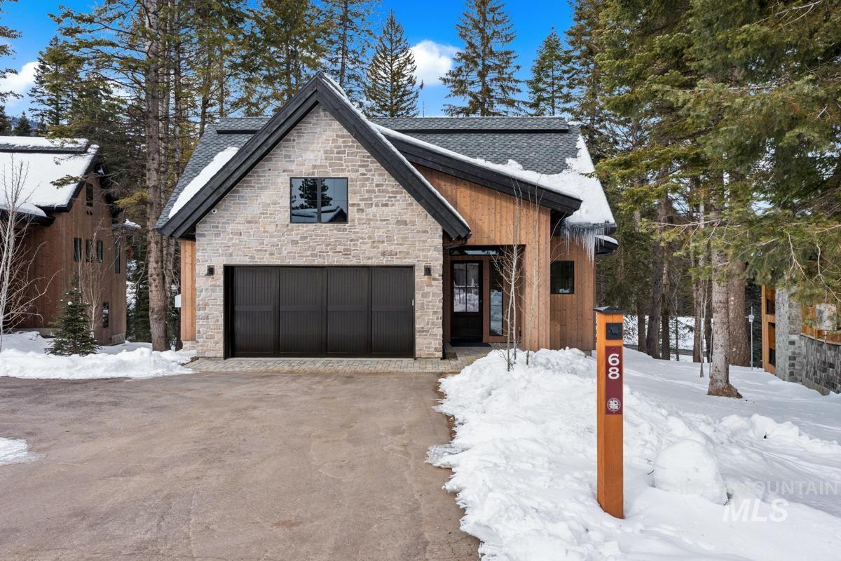 68 Ponderosa Ridge Donnelly, ID 83615 - Photo 7 of 29 View of front of property with stone siding, a garage, and asphalt driveway