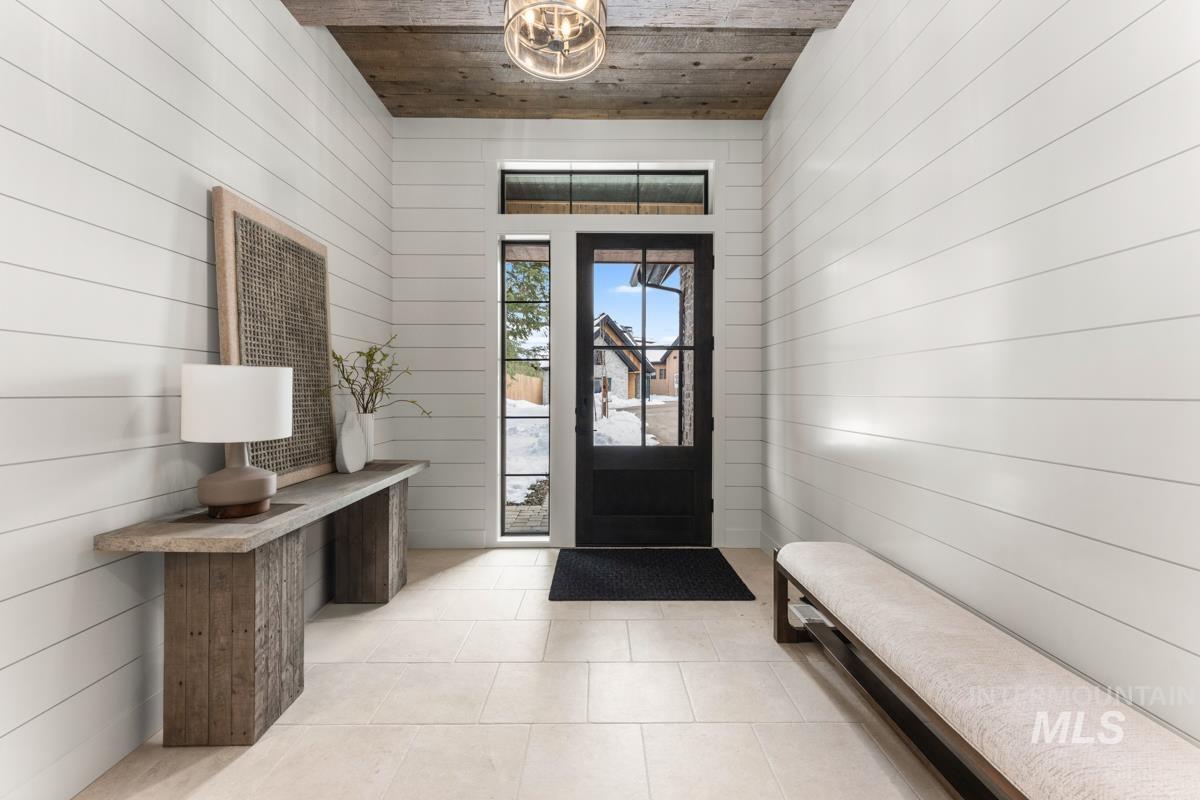 68 Ponderosa Ridge Donnelly, ID 83615 - Photo 8 of 29 Entryway featuring wooden ceiling, wood walls, and light tile patterned floors