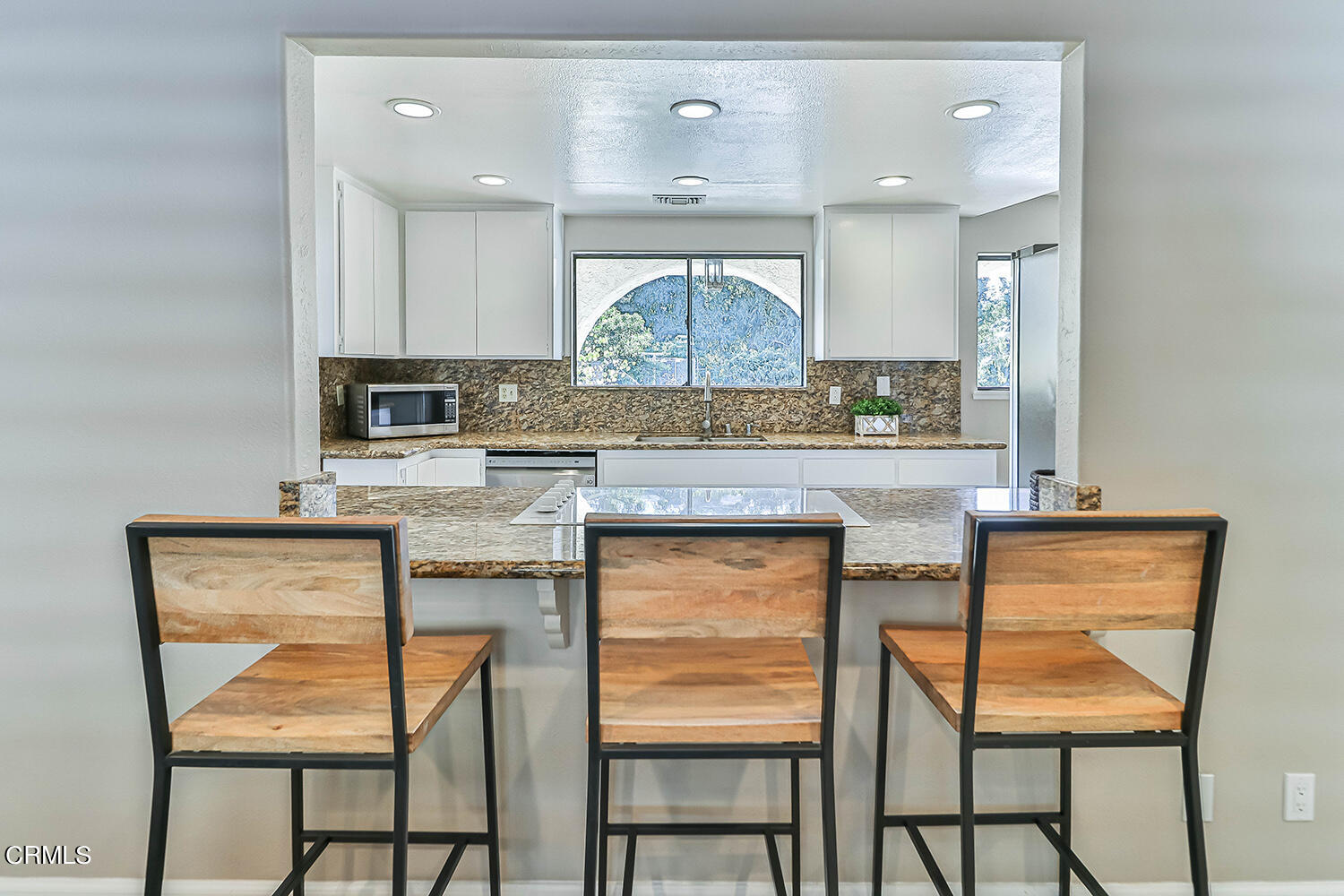 4030 Donlon Road Somis, CA 93066 - Photo 16 of 48 a kitchen with granite countertop wooden cabinets and chairs