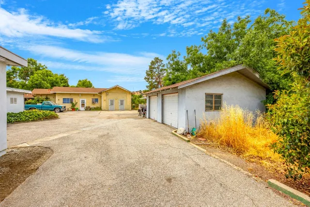 a yellow house with trees in front of it