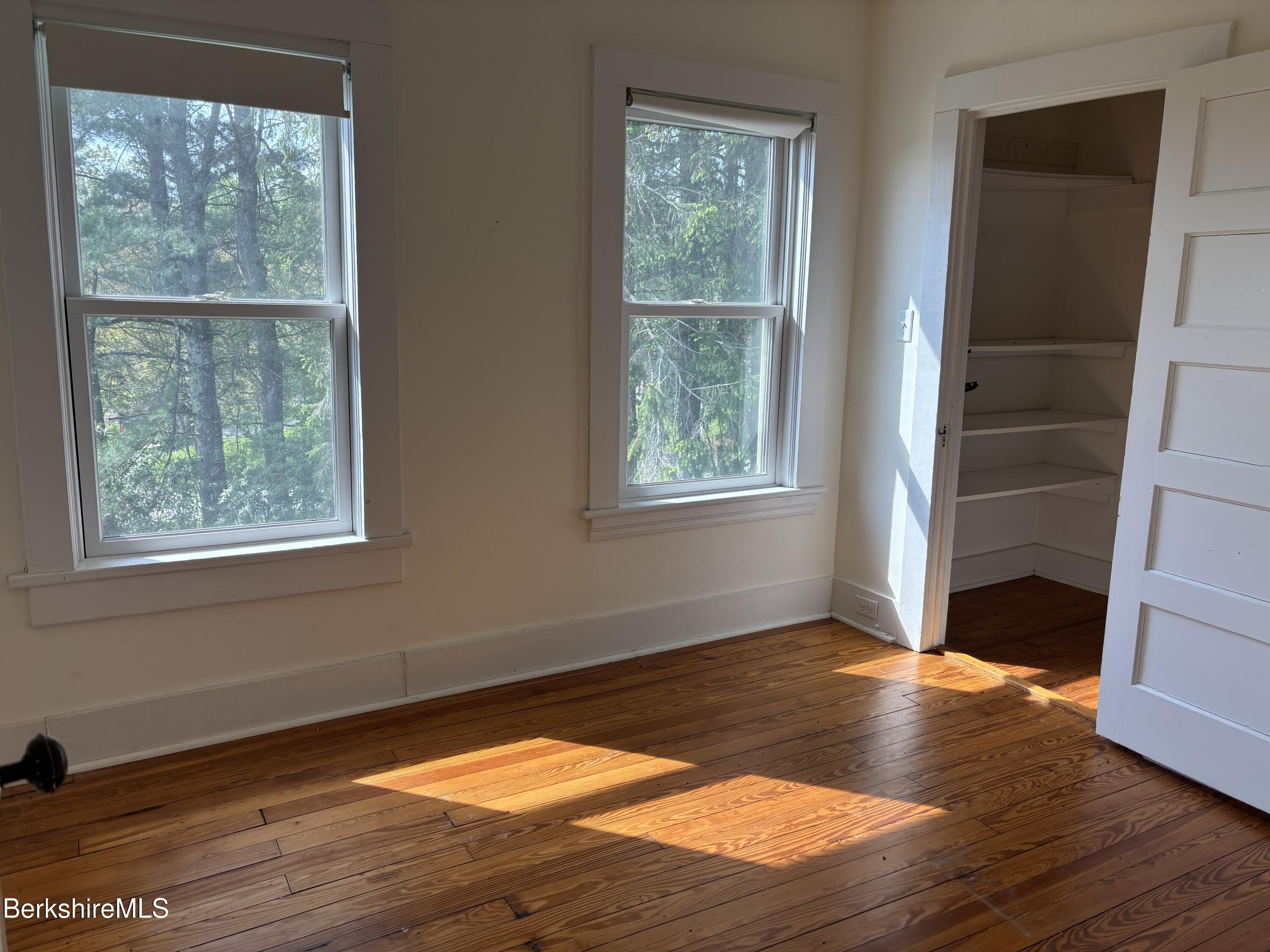 86 Miner Road Lanesborough, MA 01237 - Photo 36 of 44 an empty room with wooden floor and windows