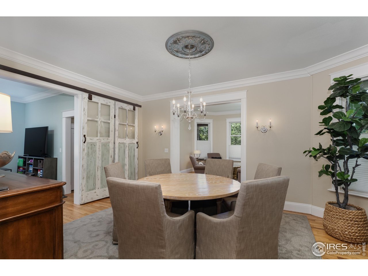 421 Highland Avenue Boulder, CO 80302 - Photo 16 of 39 a dining room with furniture potted plants and wooden floor