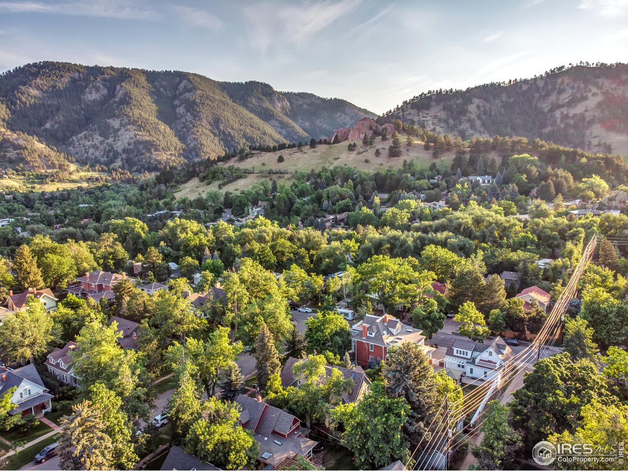 421 Highland Avenue Boulder, CO 80302 - Photo 3 of 39 a view of a lush green field with mountains in the background