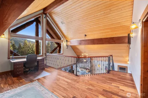 a view of porch with two chairs and wooden floor