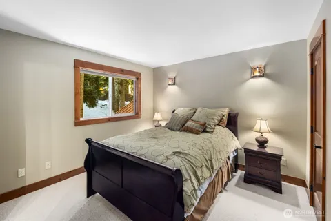 a bedroom with a bed and a night stand