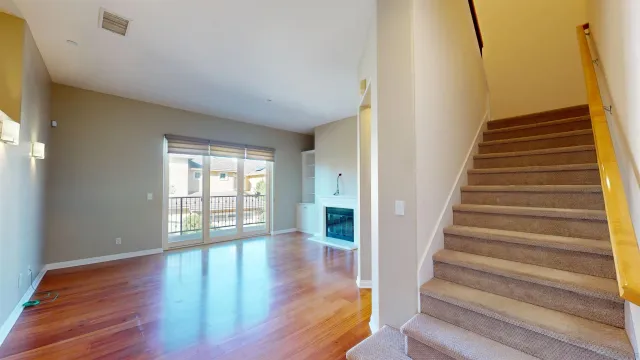 a view of an entryway with wooden floor and door