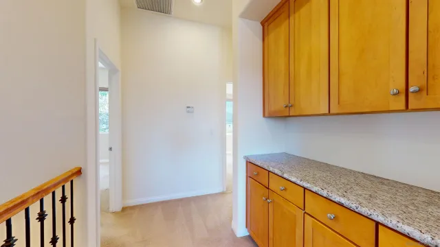 a view of a kitchen with wooden floor and cabinets