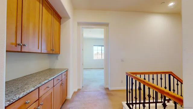 a view of a kitchen with wooden floor and cabinets