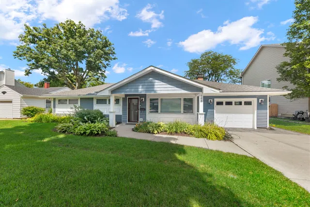a front view of a house with a garden and porch