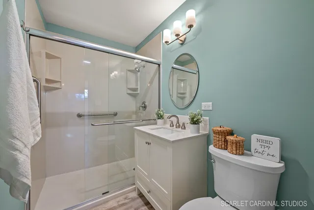 a bathroom with a toilet a sink and a mirror