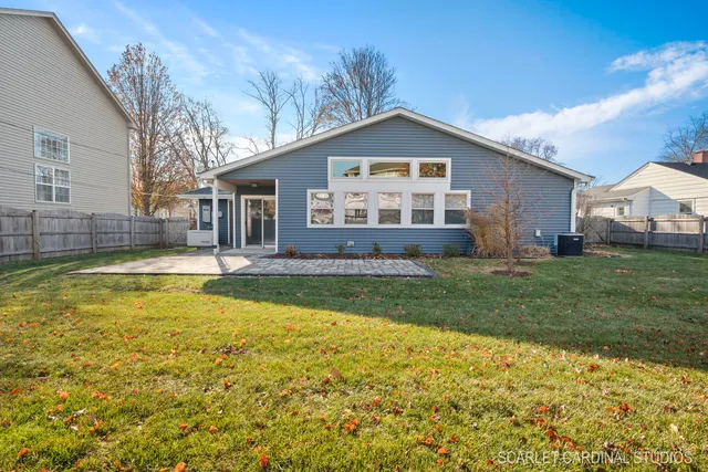 a view of a house with a yard table and chairs