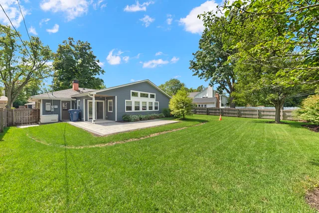 a view of house with a backyard