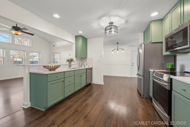 a kitchen with kitchen island granite countertop a sink cabinets and stainless steel appliances
