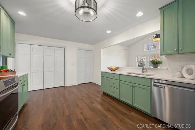 a kitchen with cabinets a sink and appliances