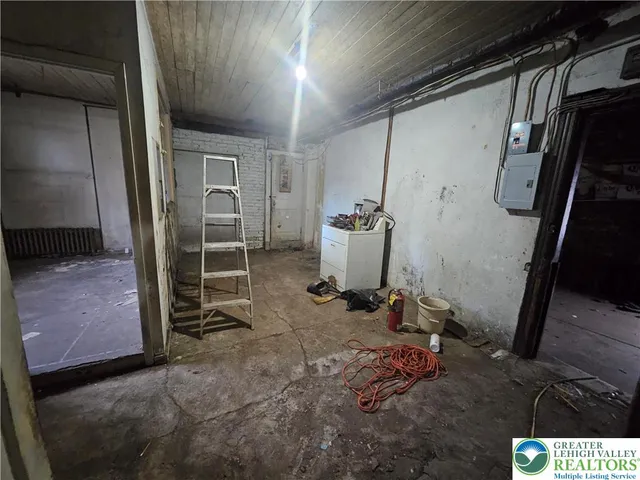 a room with water heater and a wooden door