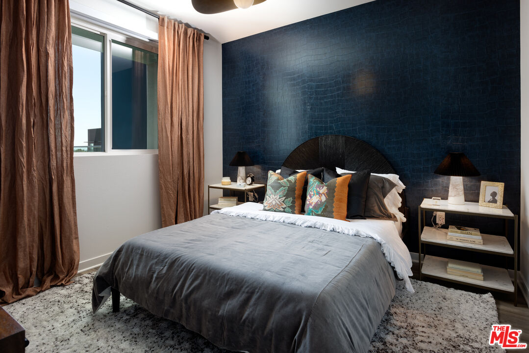 1100 Steely, Unit 1322 Irvine, CA 92614 - Photo 2 of 4 a bedroom with a bed and a mirror