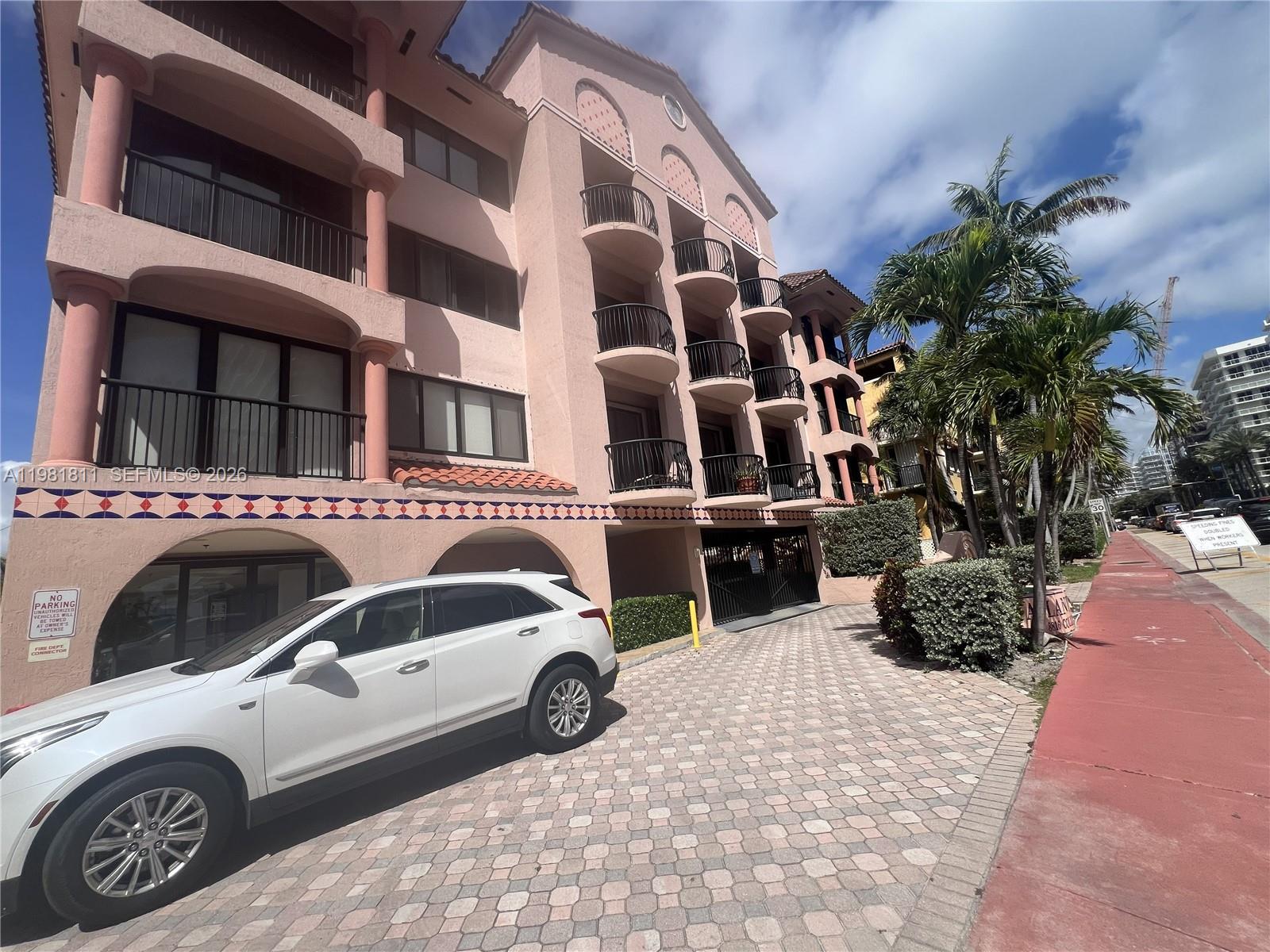 8816 Collins Avenue, Unit 105 Surfside, FL 33154 - Photo 1 of 30 a view of car parked in front of building