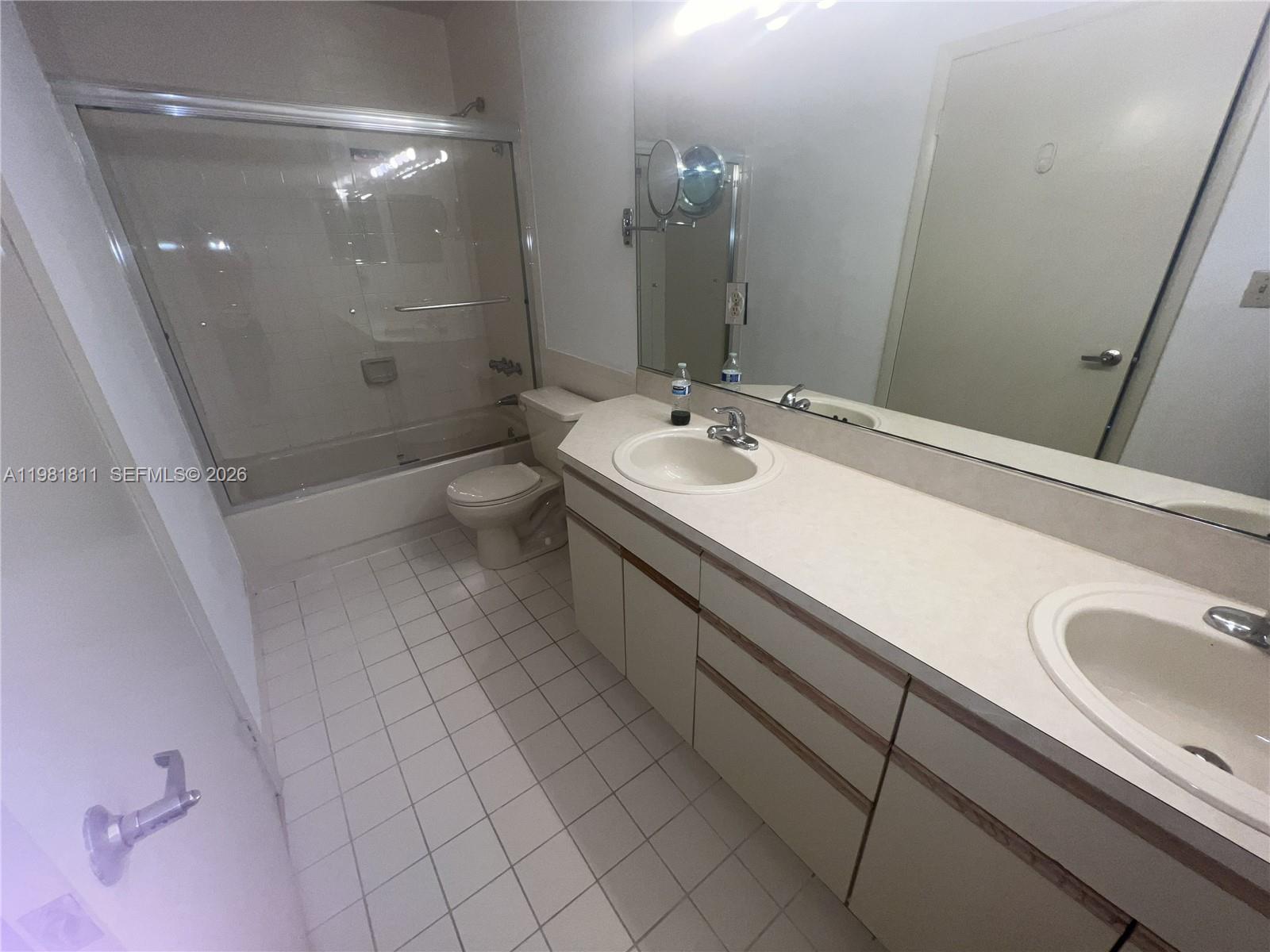 8816 Collins Avenue, Unit 105 Surfside, FL 33154 - Photo 19 of 30 a bathroom with a sink a toilet and shower
