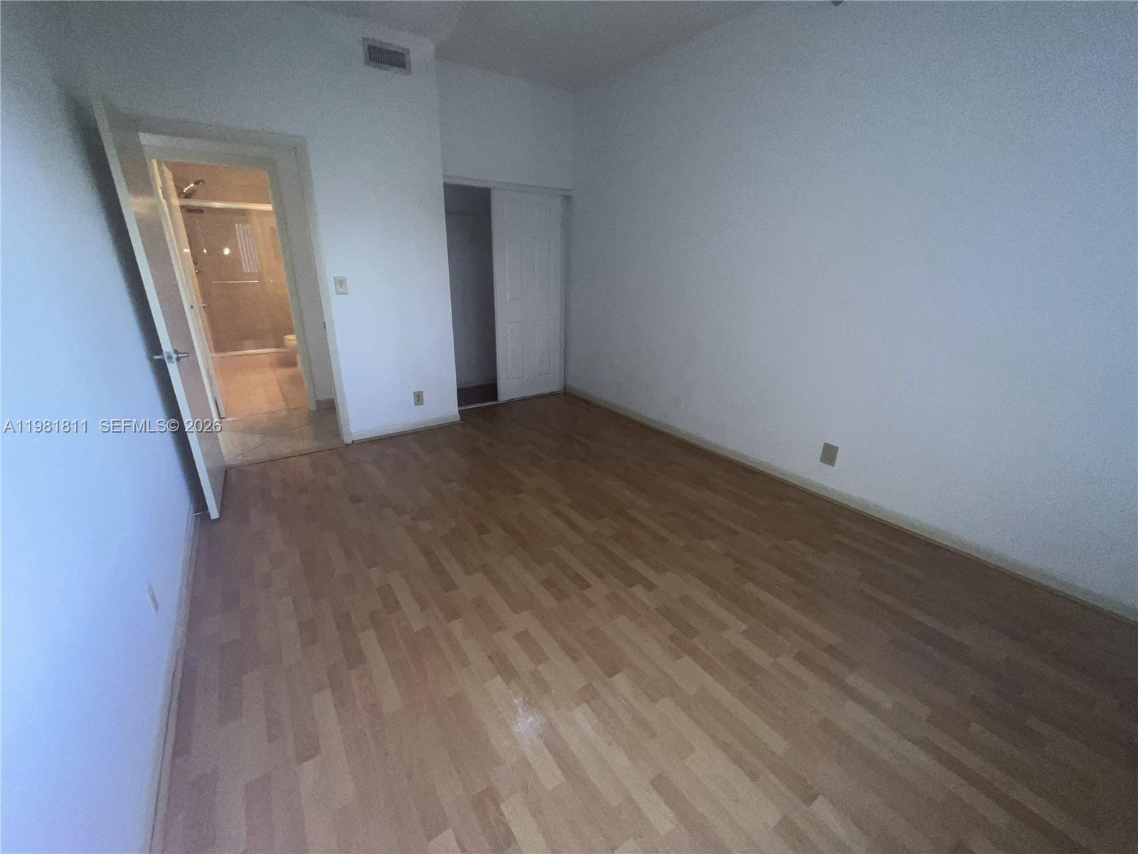 8816 Collins Avenue, Unit 105 Surfside, FL 33154 - Photo 21 of 30 a view of a room with wooden floor and stairs