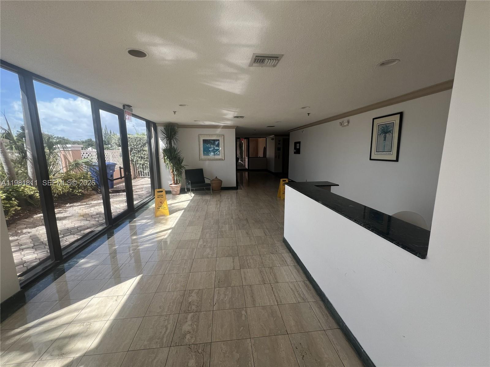 8816 Collins Avenue, Unit 105 Surfside, FL 33154 - Photo 26 of 30 a hallway with a large window