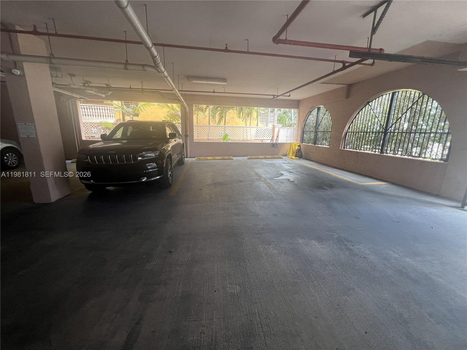8816 Collins Avenue, Unit 105 Surfside, FL 33154 - Photo 28 of 30 a view of car parked in garage