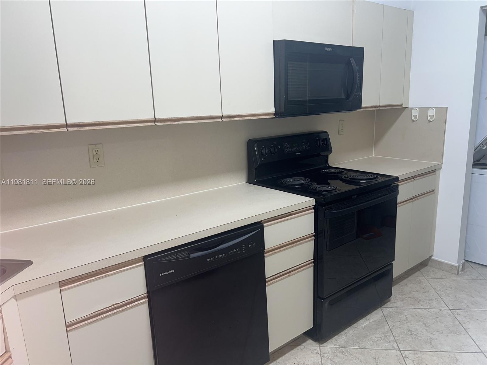 8816 Collins Avenue, Unit 105 Surfside, FL 33154 - Photo 8 of 30 a kitchen with a sink and cabinets