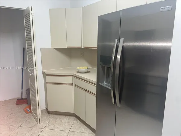 a kitchen with a refrigerator and a stove