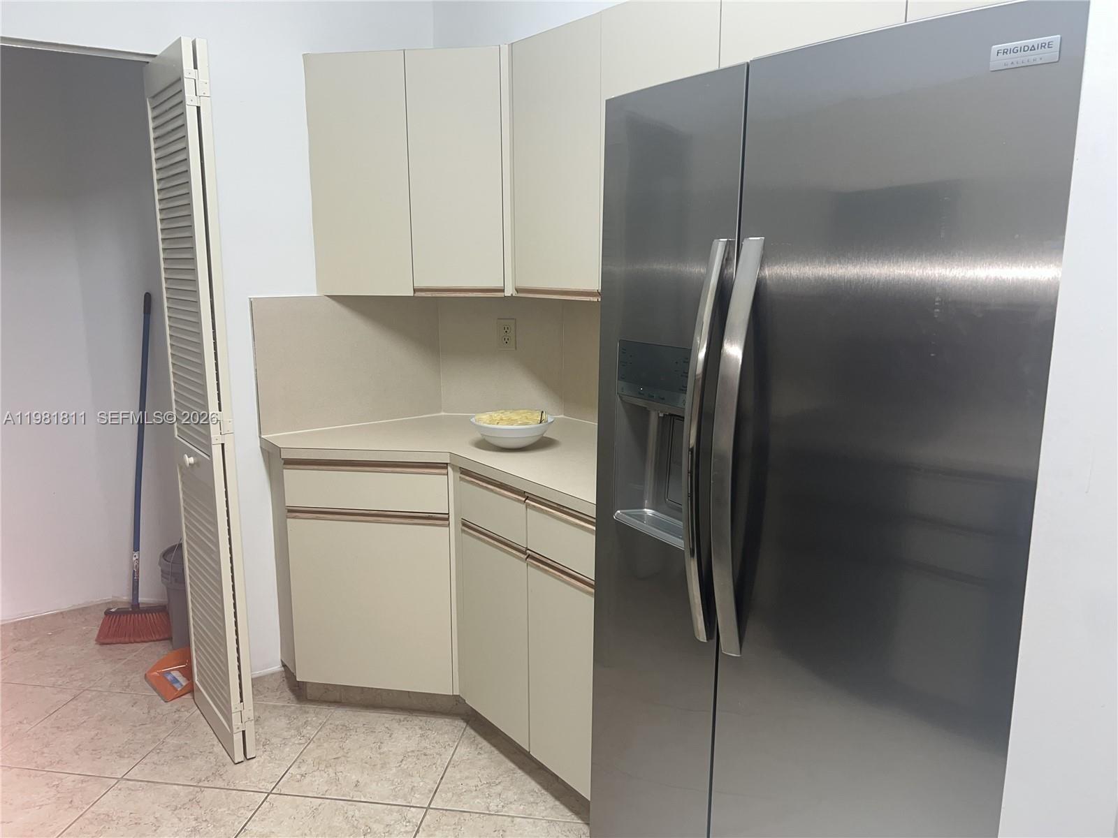 8816 Collins Avenue, Unit 105 Surfside, FL 33154 - Photo 9 of 30 a utility room with cabinets