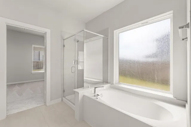 a bathroom with a bathtub and a shower