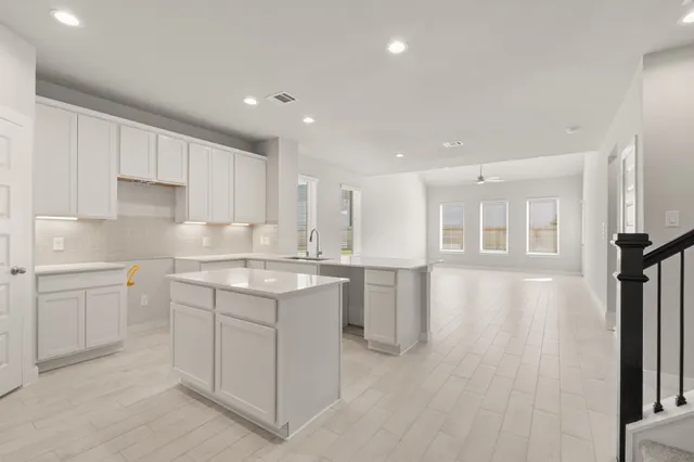 a kitchen with a sink microwave and cabinets