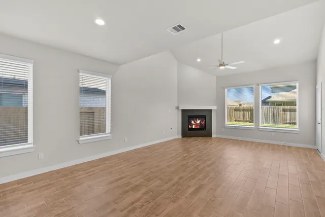 an empty room with windows and closet