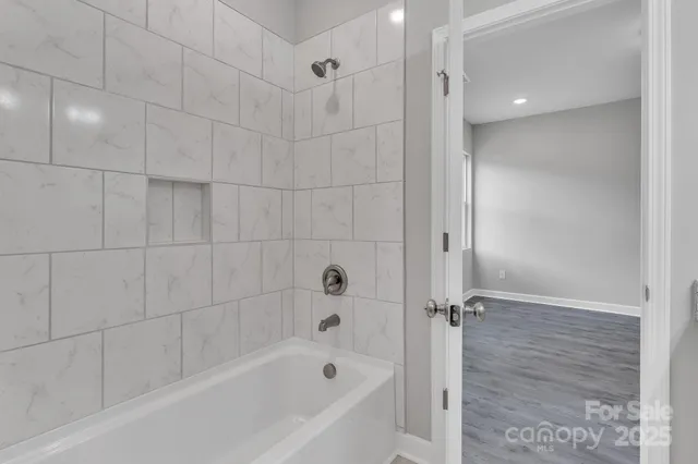 a bathroom with a bathtub and shower