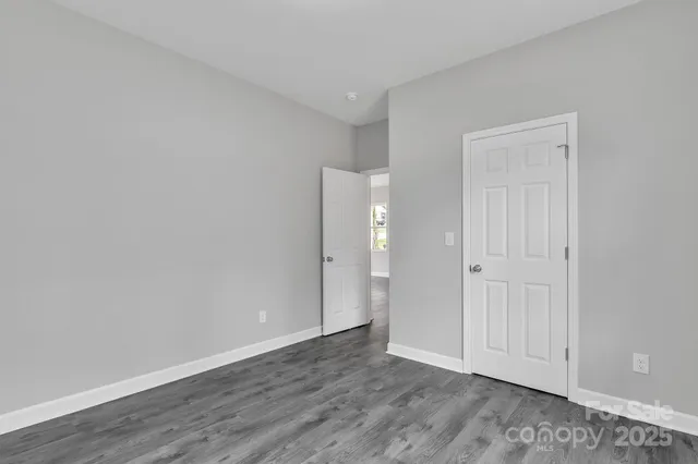 a view of an empty room and wooden floor