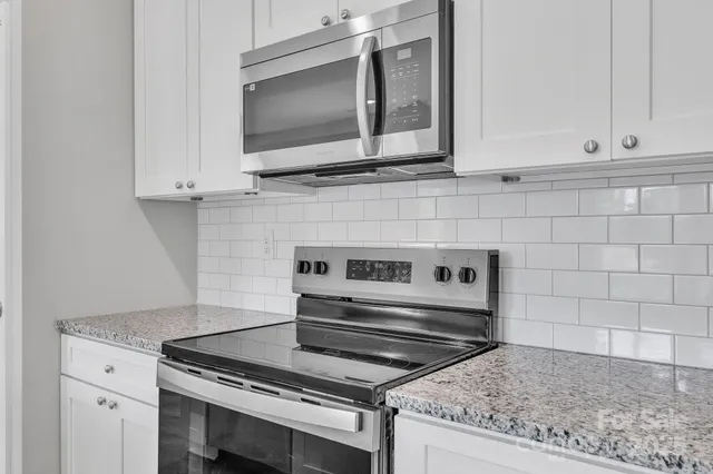 a stove top oven sitting inside of a kitchen